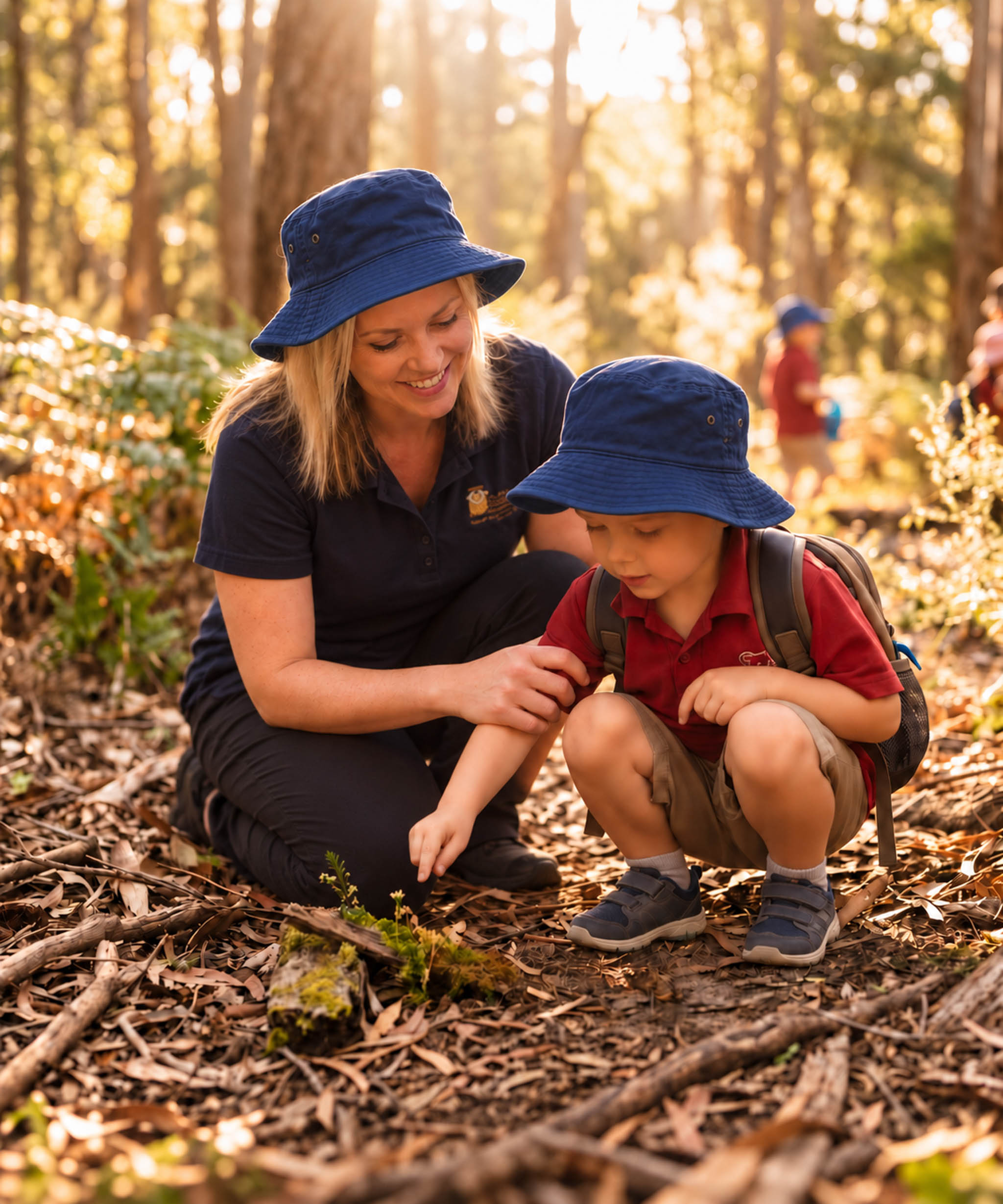 An educator guiding a child through a hands-on woodland discovery